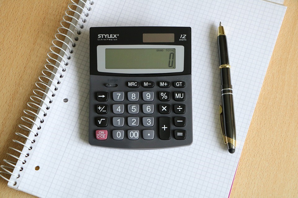 Calculator and a pen on a piece of paper