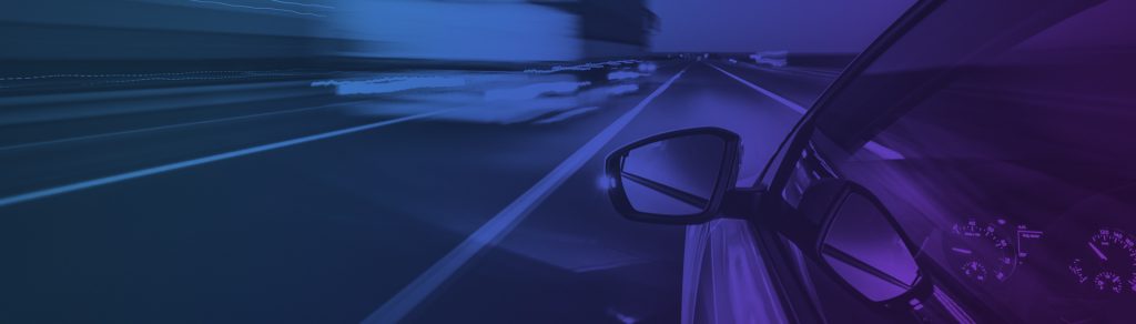 blue purple image of a car driving