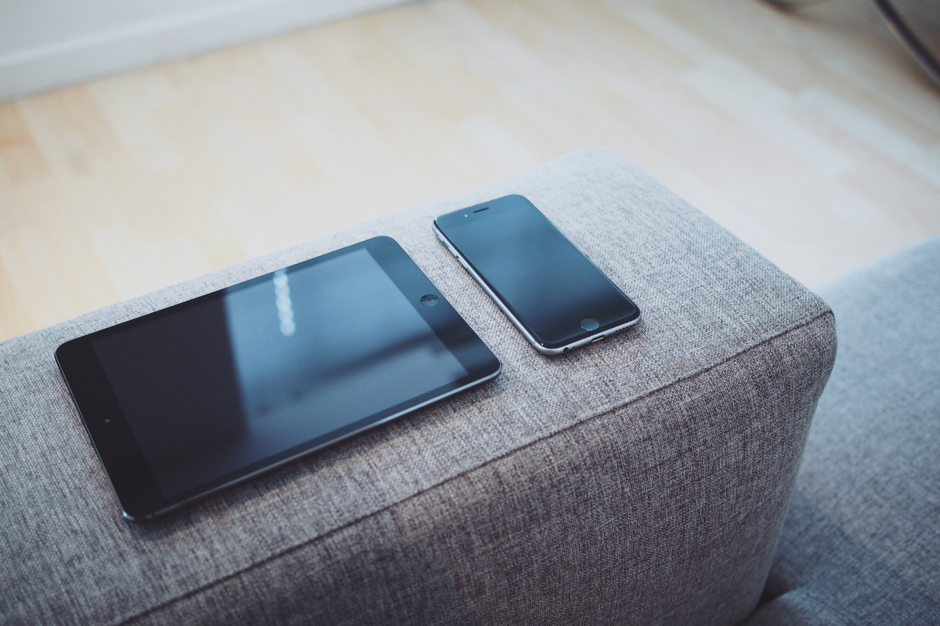 black ipad and iphone on armchair