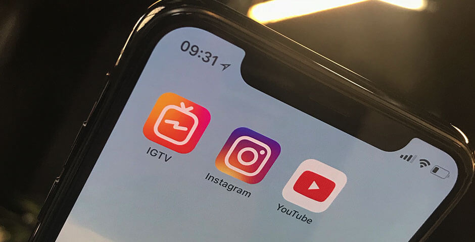 A phone displaying app icons for IGTV, Instagram and YouTube